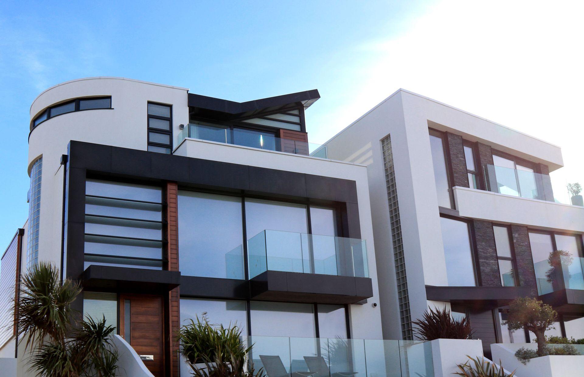 Modern home with large solar-control glass and a dark, even exterior look