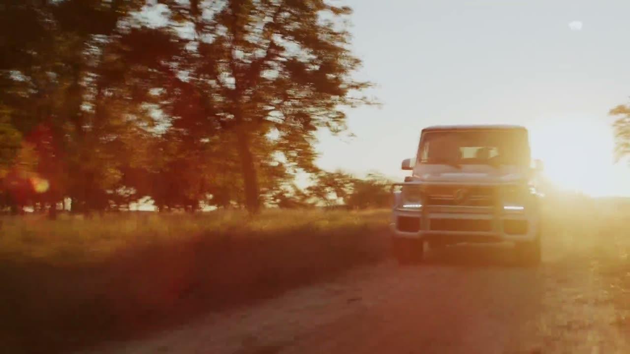 White SUV on a dirt road at sunset