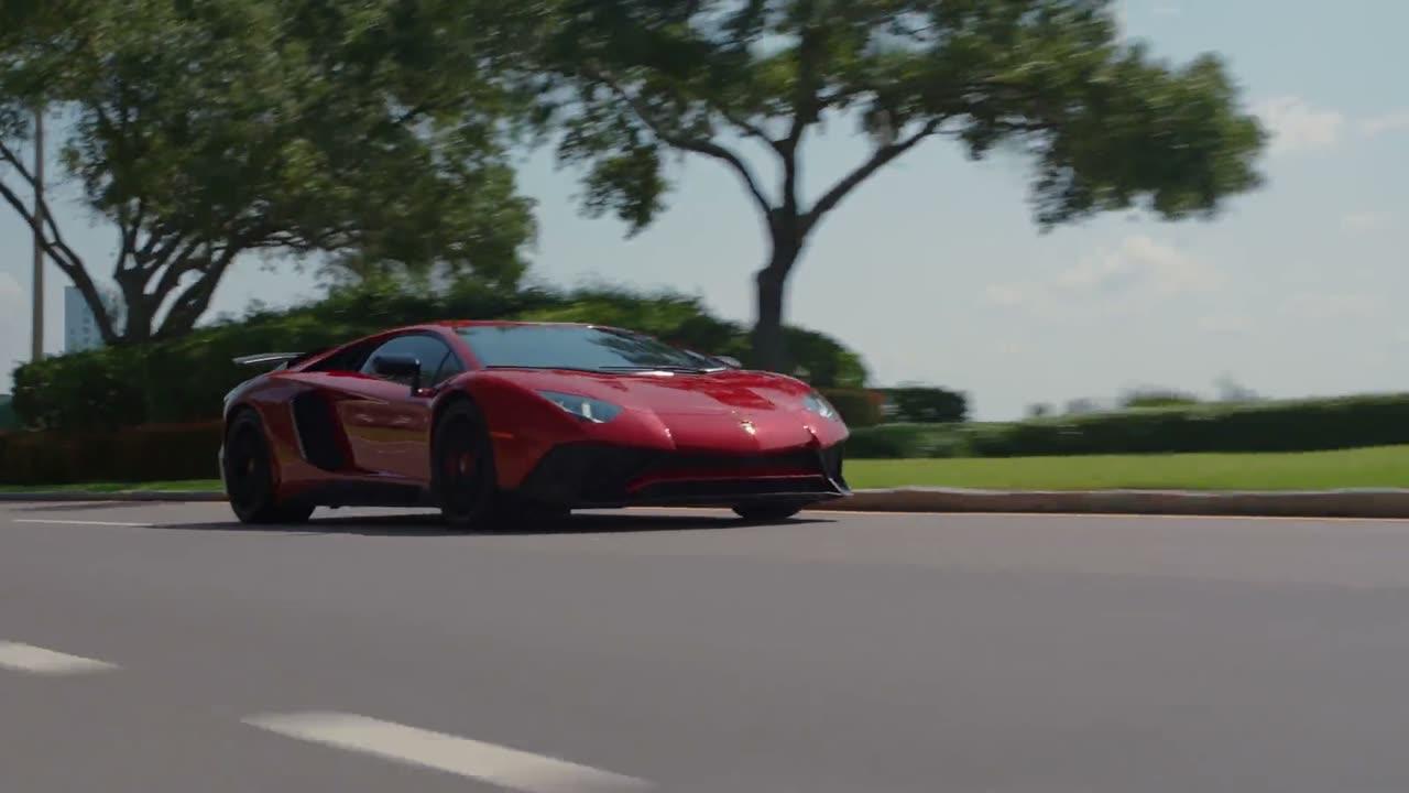 Red Lamborghini on a waterfront road